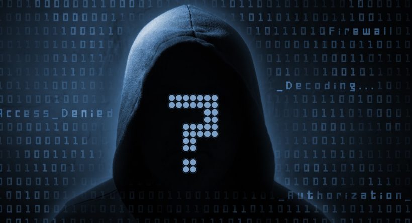 hooded computer hacker in the shadow with binary codes